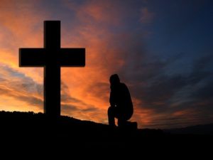 Man Praying at Cross